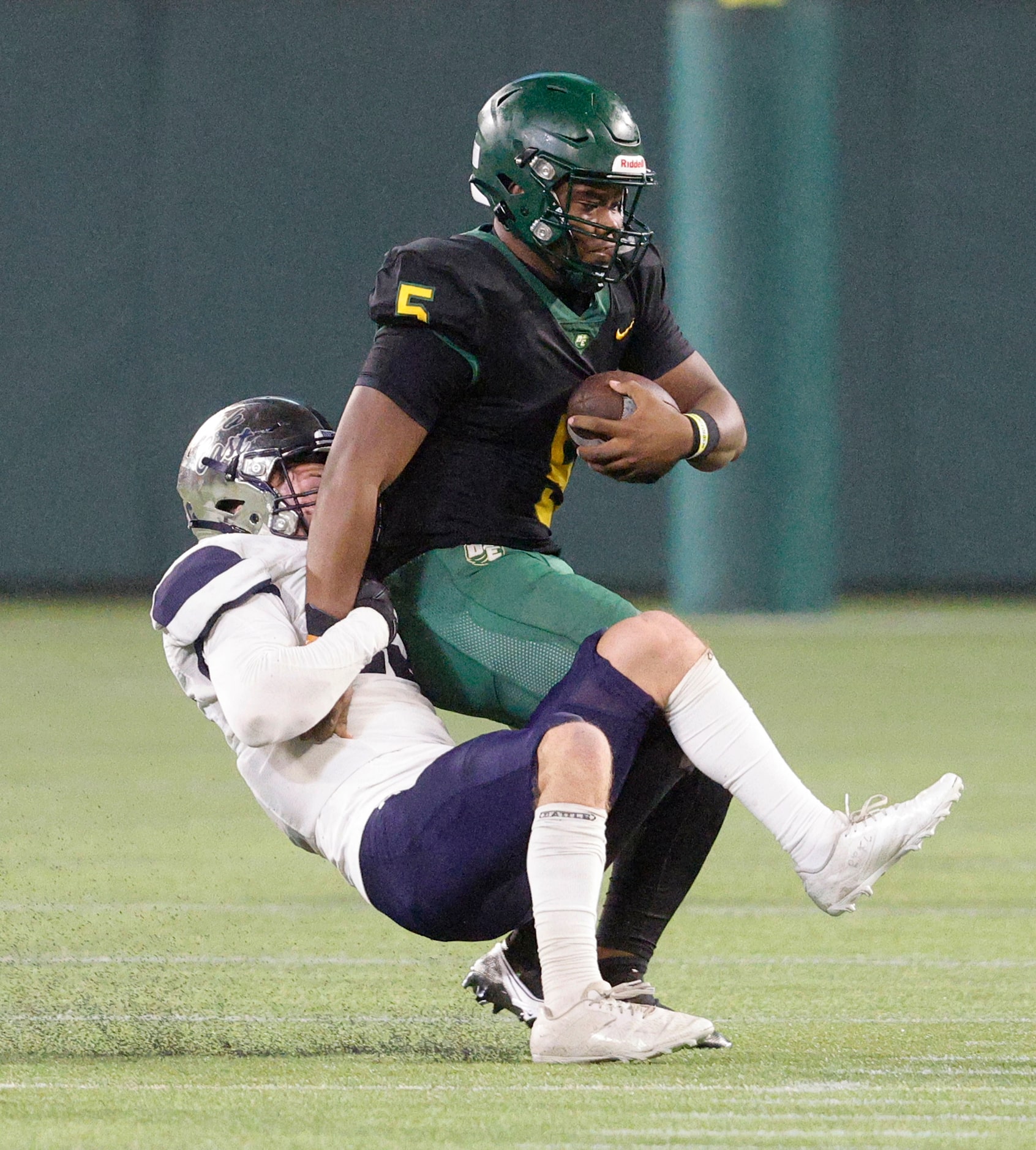 DeSoto's Darius Bailey (5) quarterback is sacked by Wylie East's Zachari Loftus (19) during...