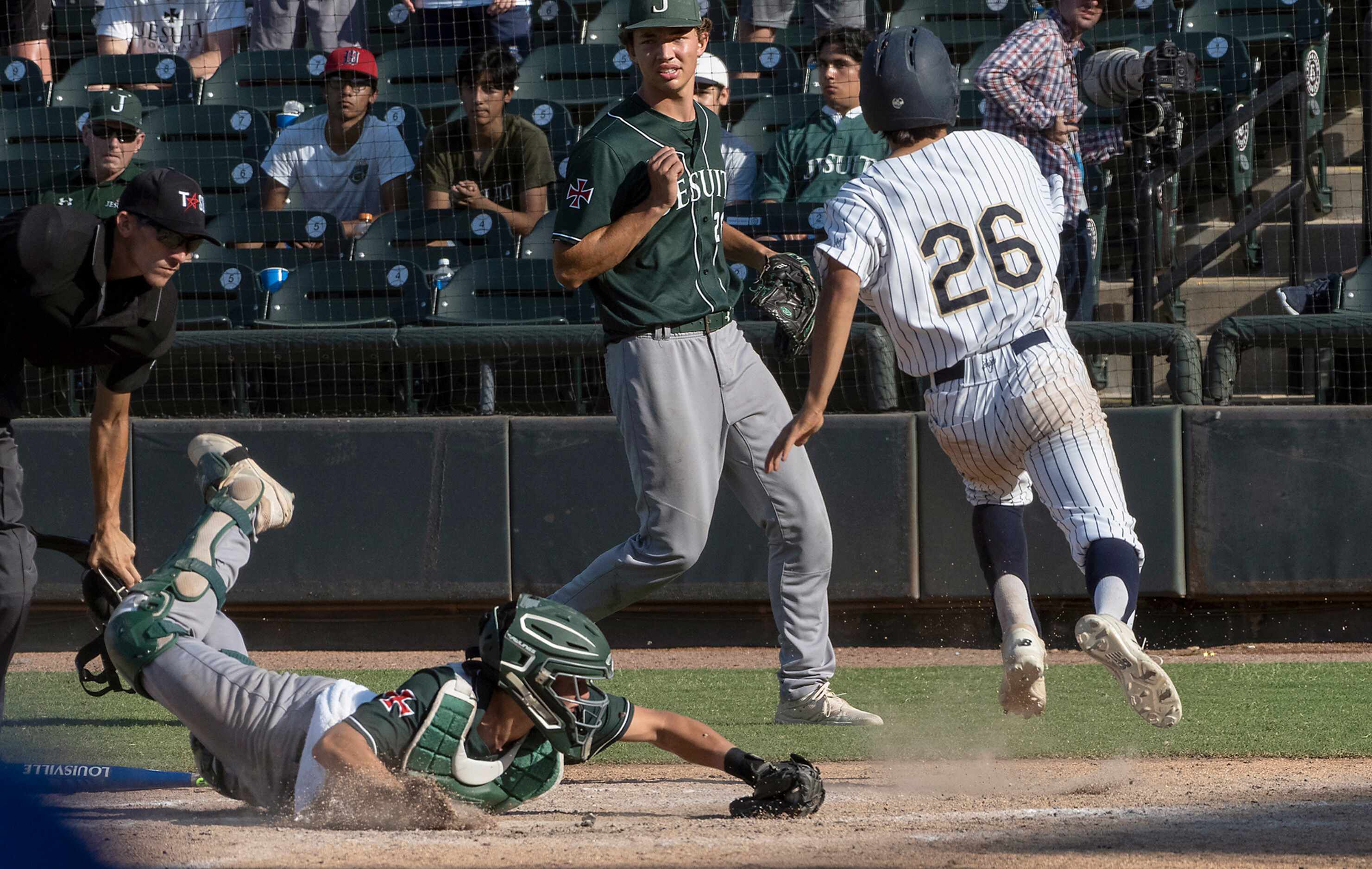 Keller Colten Vargas, (26), beats the tag at home plate by Houston Strake Jesuit catcher,...