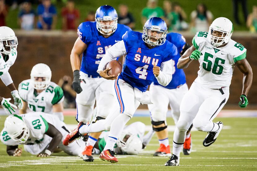 SMU quarterback Matt Davis (4) breaks through the North Texas defense on a 50-yard touchdown...