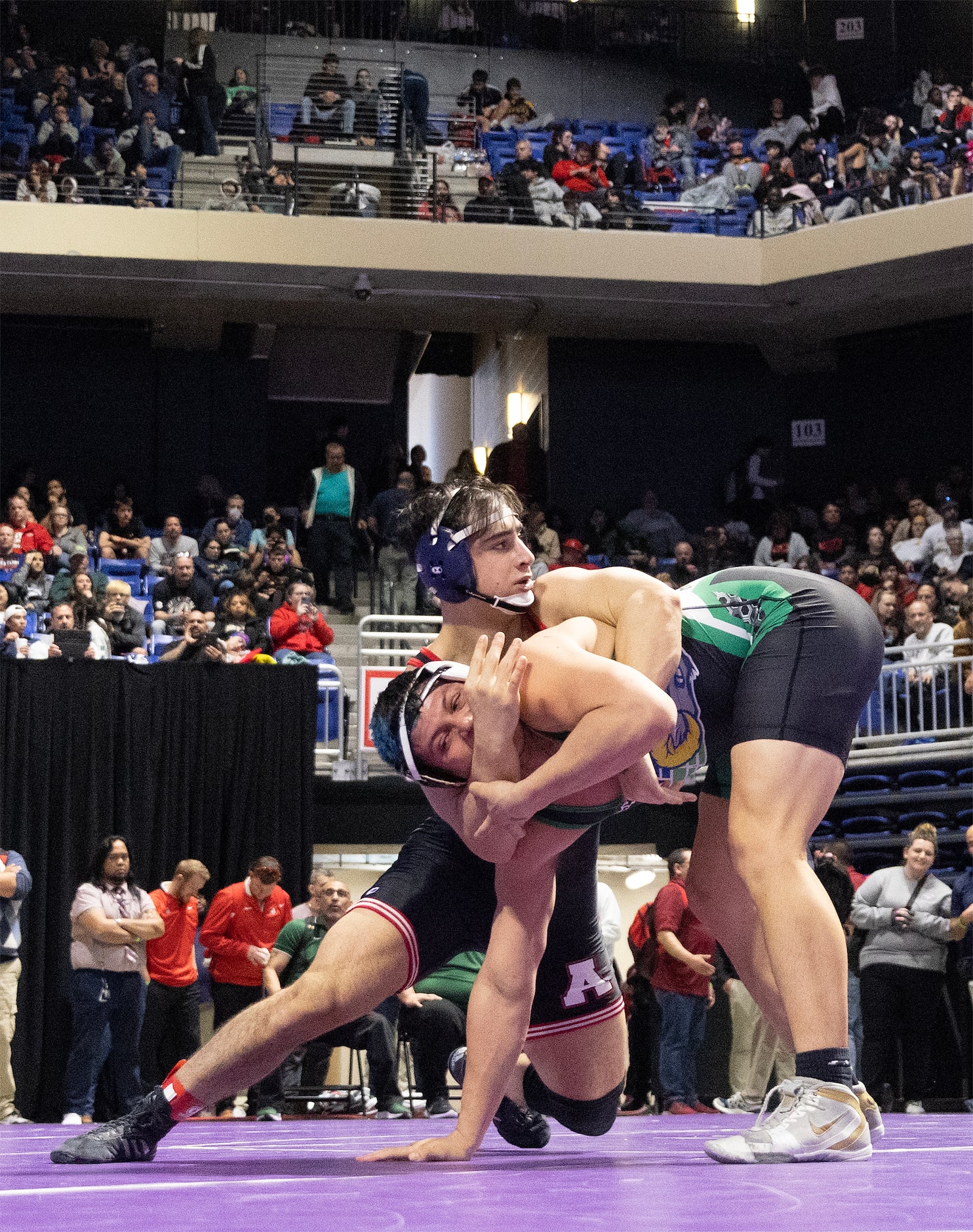 Ryan Nichols from Allen (top) wrestles Jose Angel Rosales in the 6A boys 215 pound division...