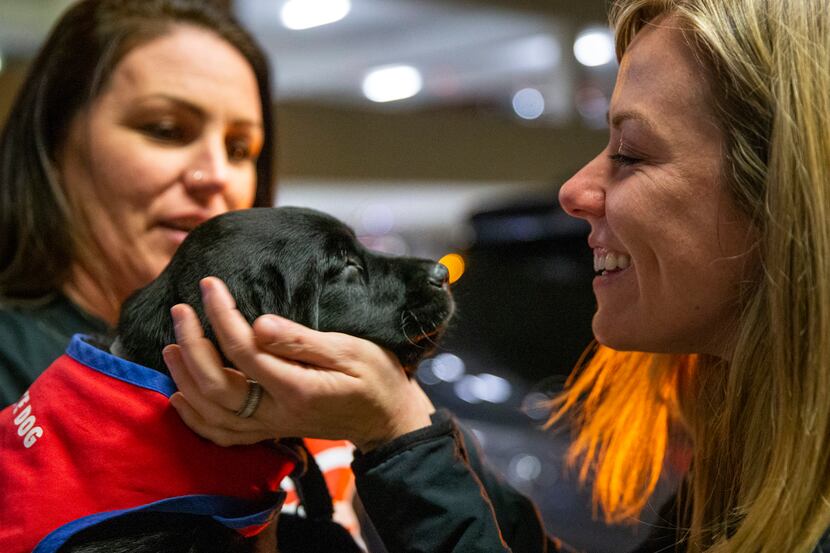 Caroline Clayton (right) says goodbye to 8-week-old Pine at DFW International Airport. The...
