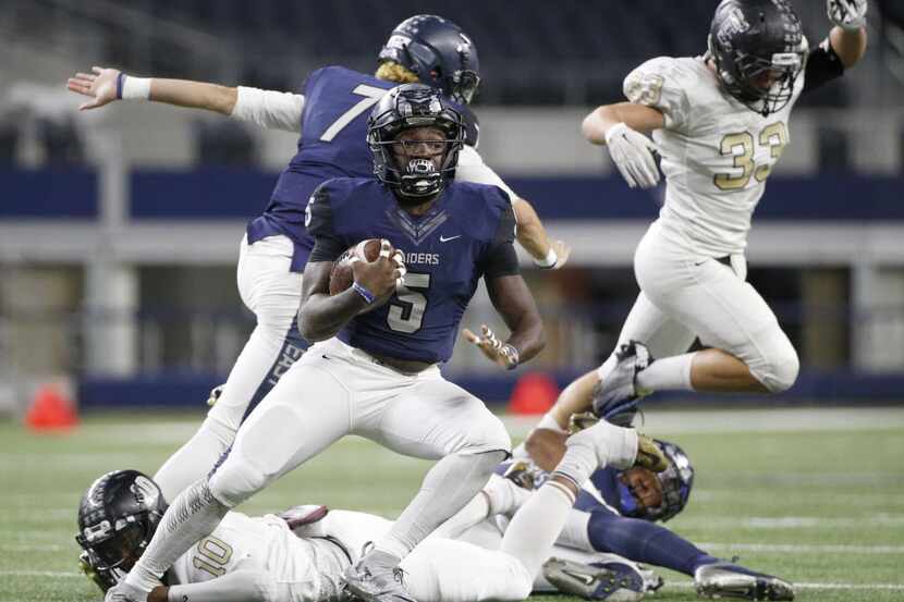 Wylie East's Eno Benjamin runs the ball against The Colony during their high school playoff...