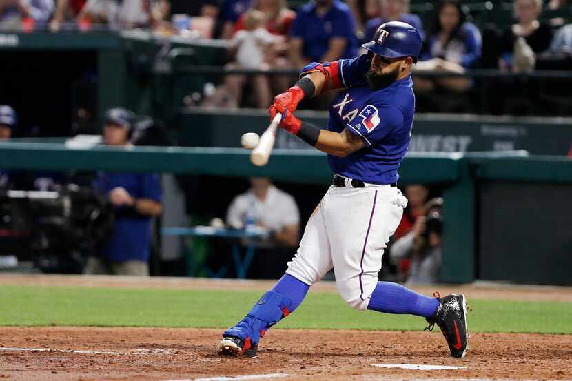 Texas Rangers' Rougned Odor (12) makes contact for a two run home run during the third...