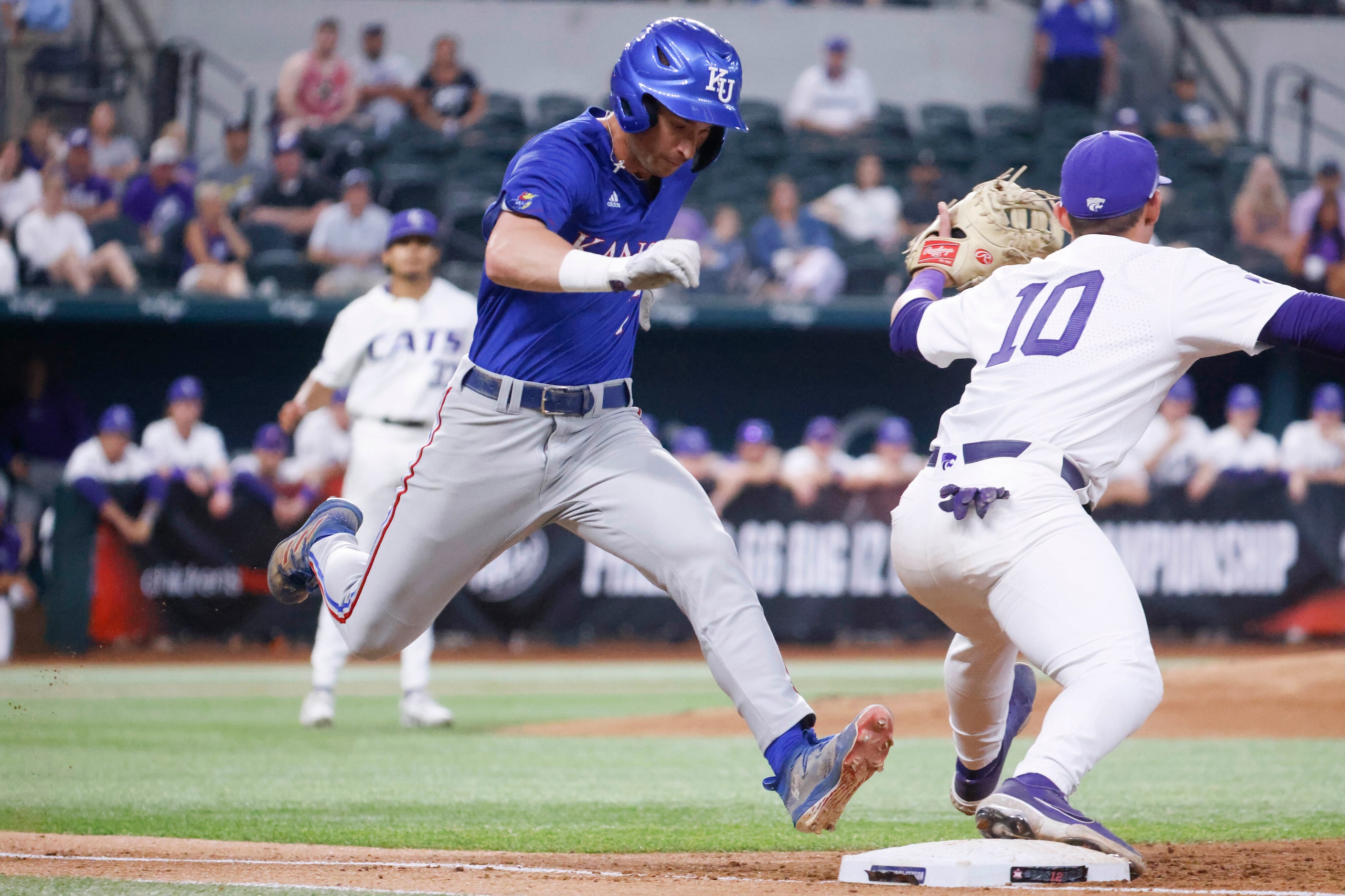 Kansas infielder Collier Cranford (left) safely reaches the first base past Kansas St....