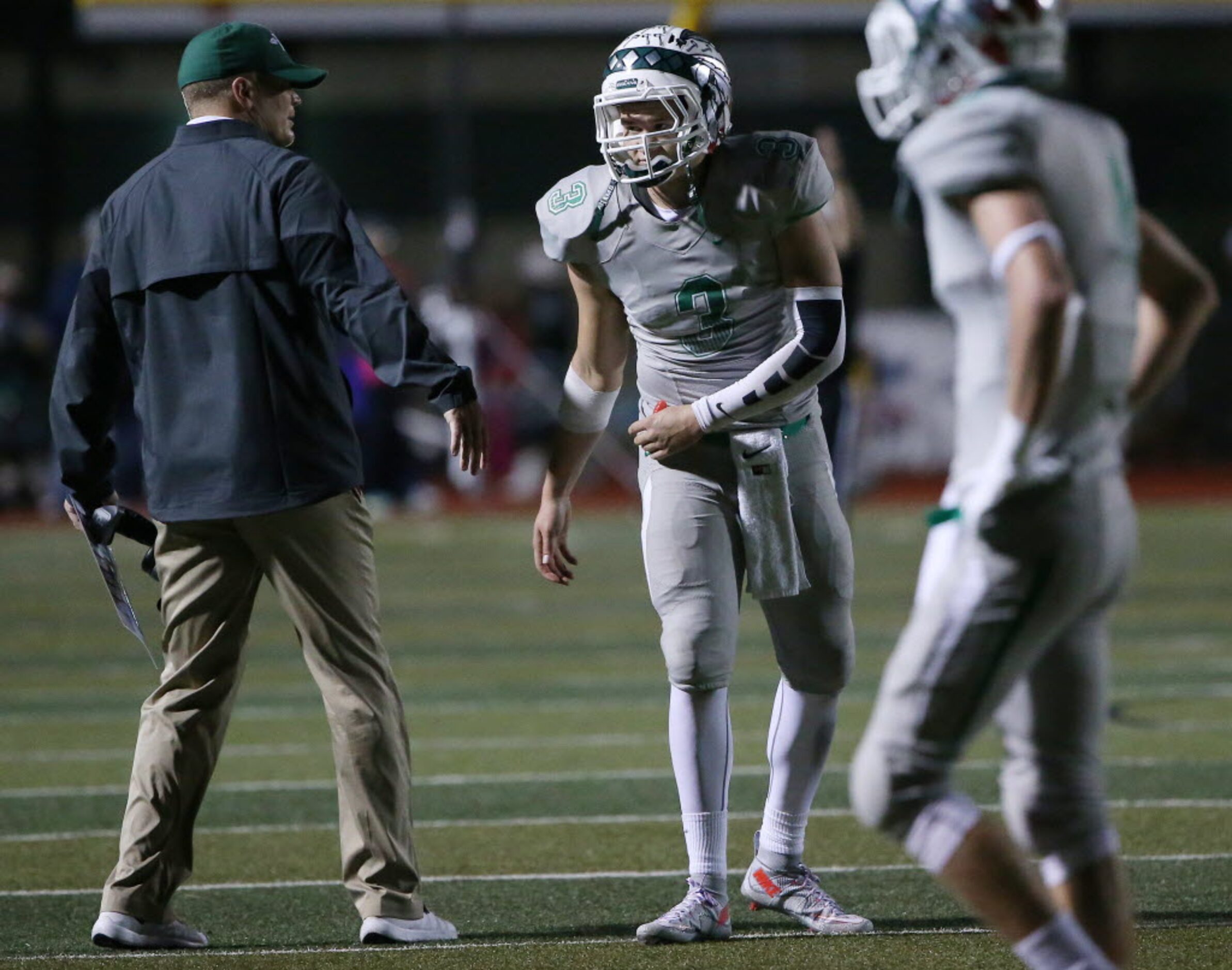 Waxahachie quarterback Jordan Kitna (3) speak to his father and head coach Jon Kitna while...