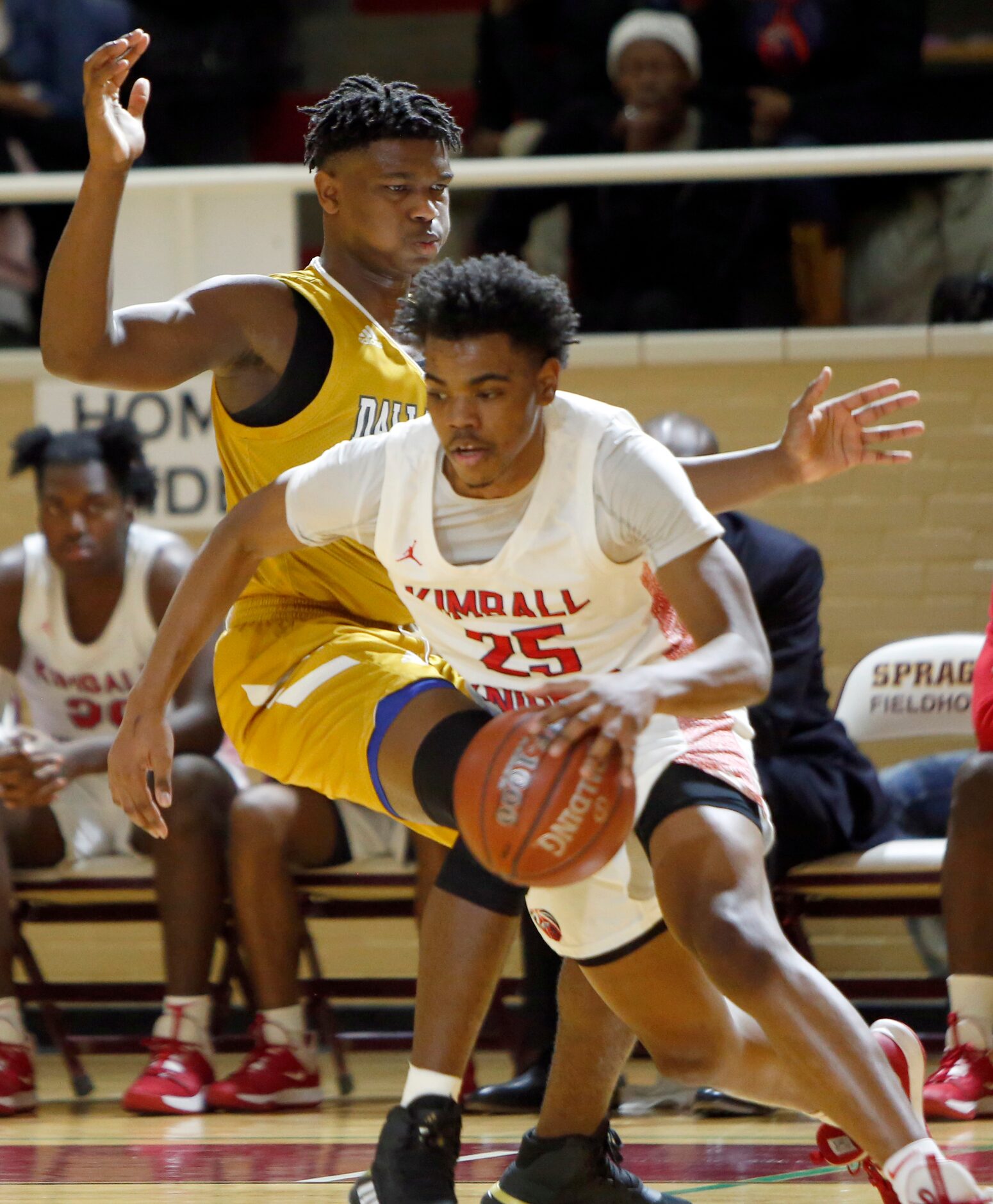 Dallas Kimball's Marcus Bonner (25) drives around the aggressive defense of Dallas South Oak...