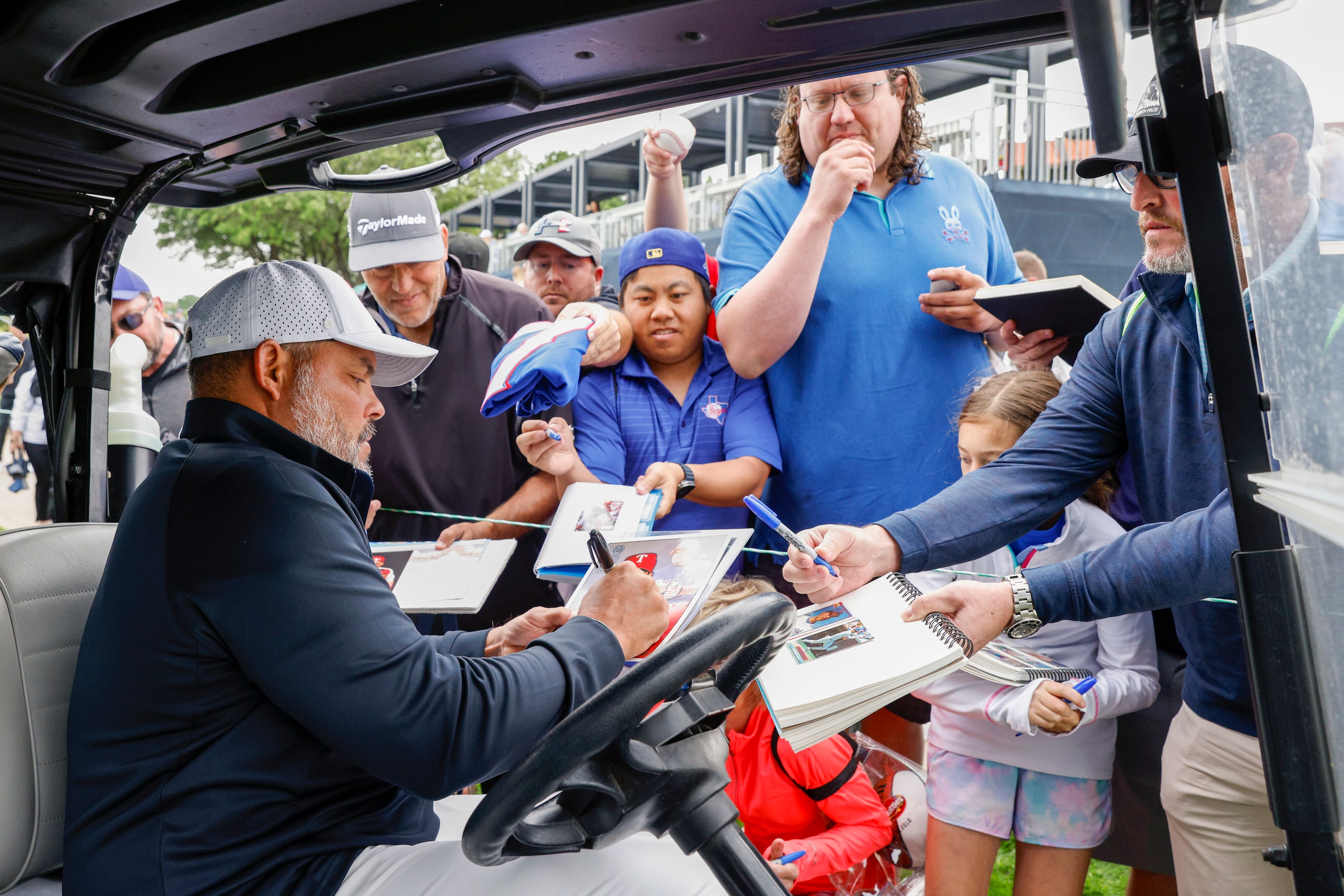 Texas Rangers Hall of Fame catcher Iván “Pudge” Rodríguez signs autographs for fans after...