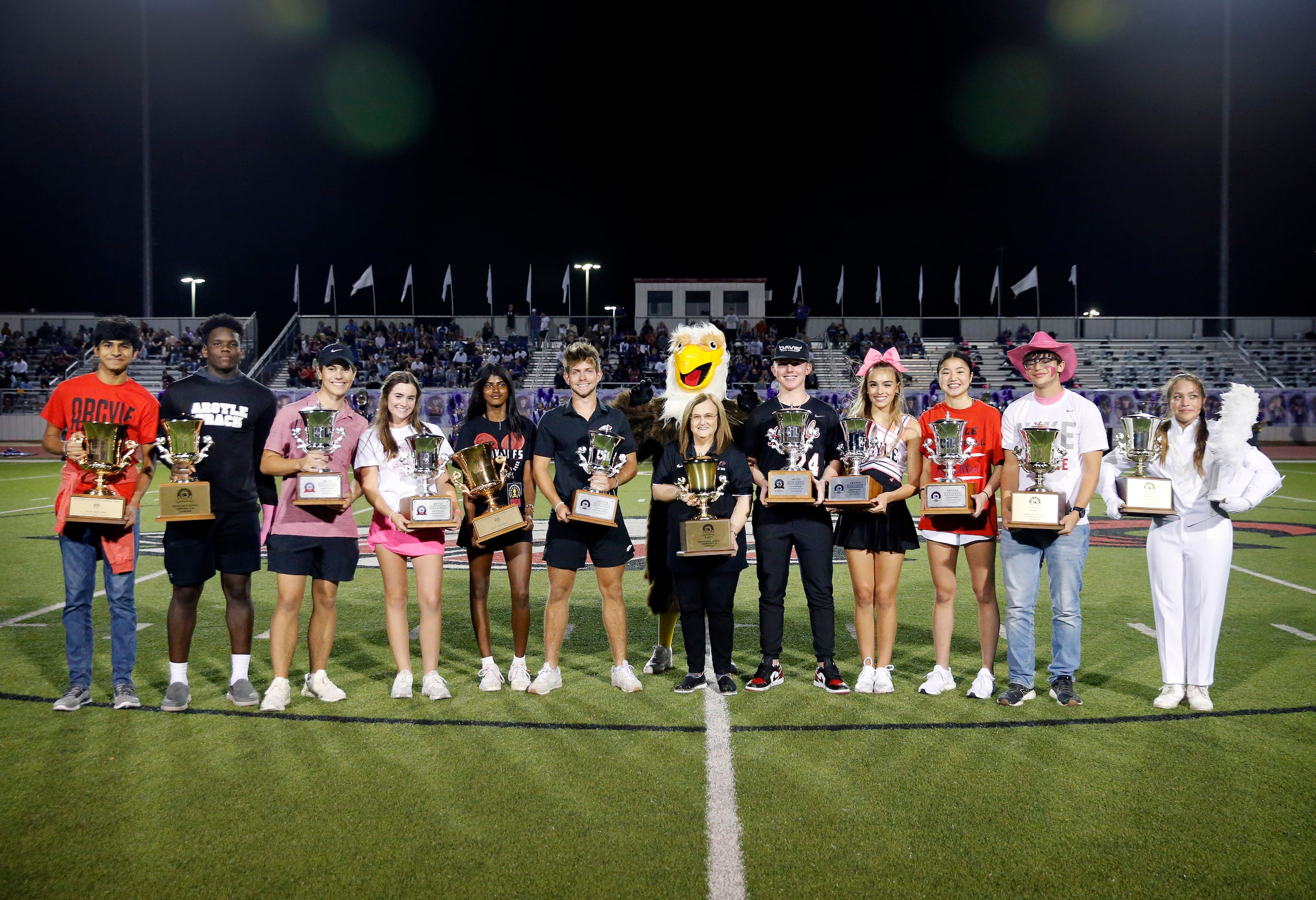 Flanked by students holding individual cups, Argyle superintendent Dr. Telena Wright...