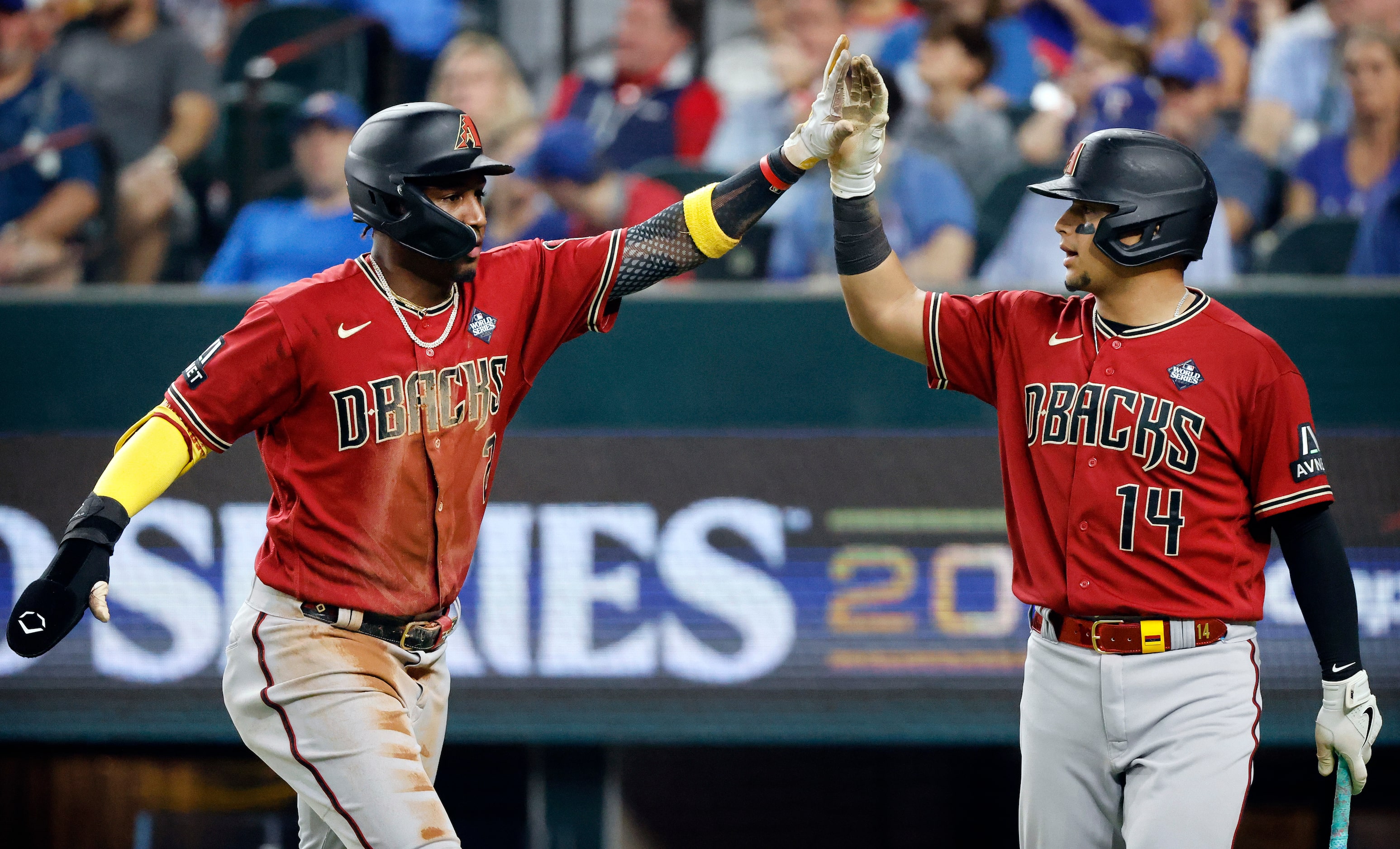 Arizona Diamondbacks' Geraldo Perdomo high-fives Gabriel Moreno after scoring on a double by...