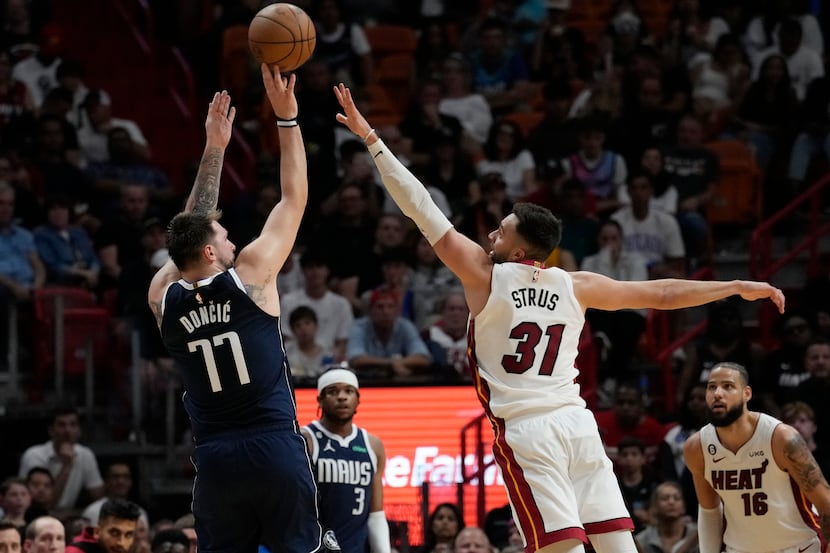 Dallas Mavericks guard Luka Doncic (77) aims to score as Miami Heat guard Max Strus (31)...