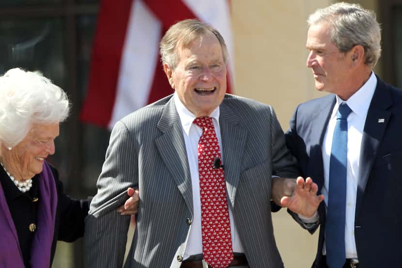 Former First Lady Barbara Bush and former President George W. Bush help former President...