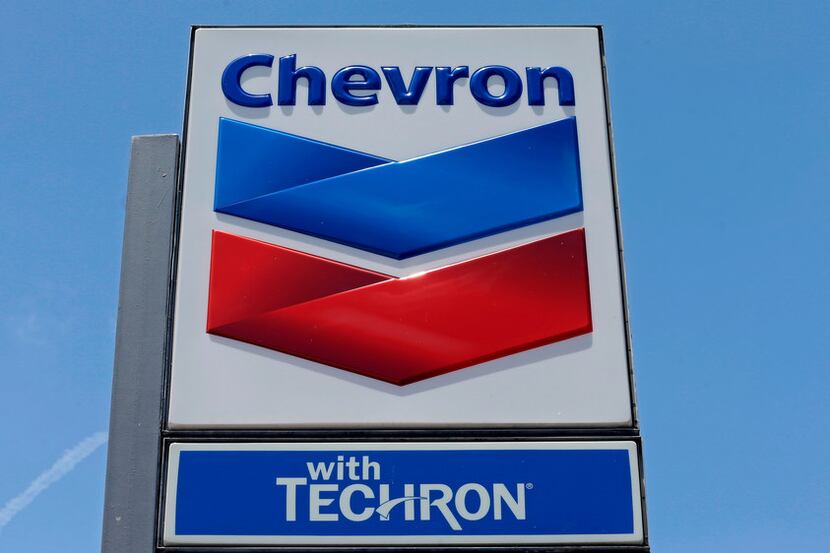 FILE - This May 2, 2017 file photo shows a Chevron sign at a gas station in Miami, Fla....