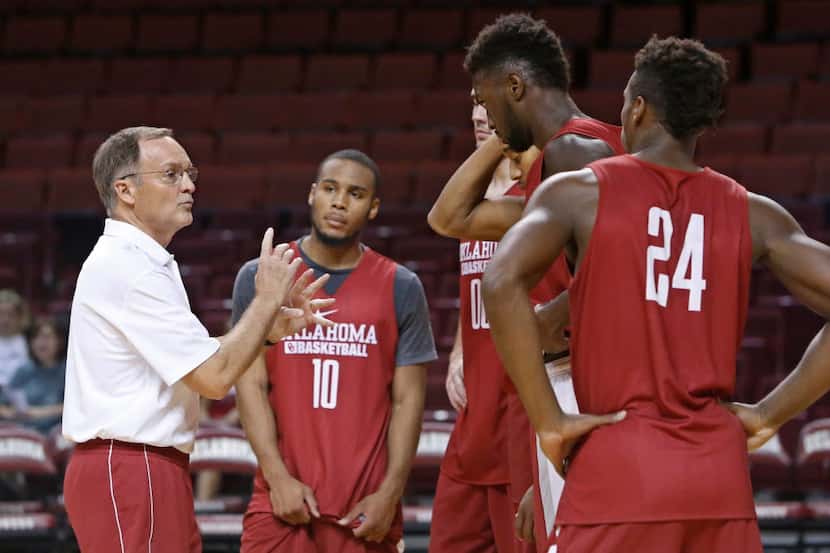 Oklahoma head coach Lon Kruger talks with his players during an NCAA college basketball...