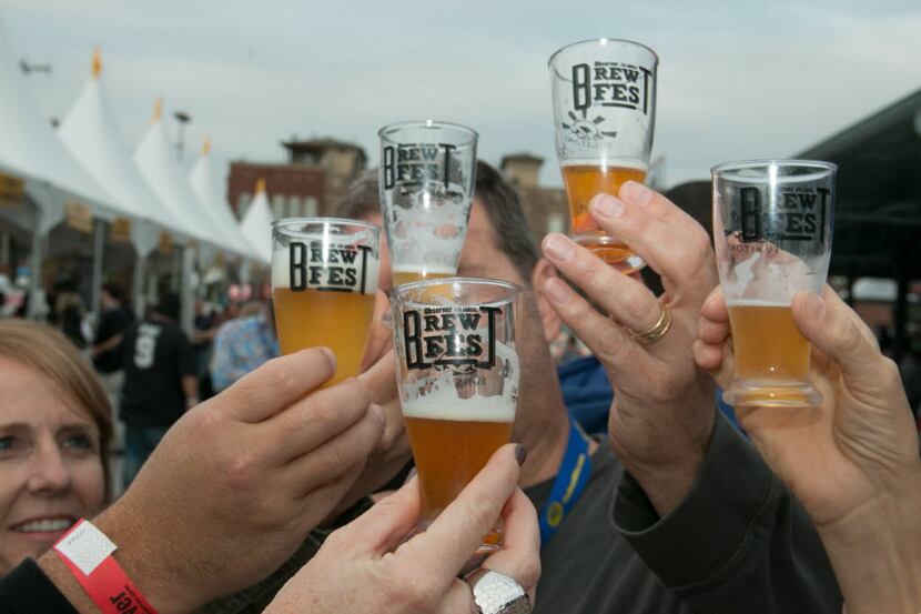 Drinkers cheers with beers at a previous Dallas Observer BrewFest.
