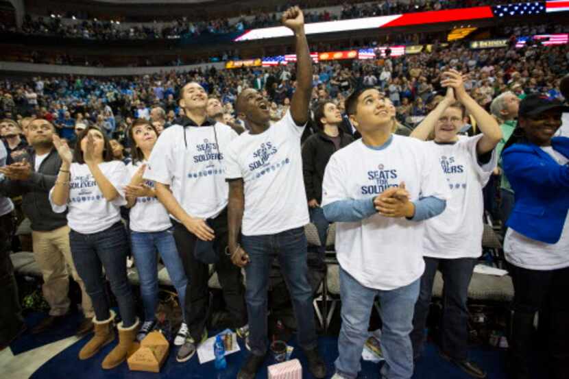  Veterans cheered from courtside seats during the Mavericks-Bucks game at American Airlines...