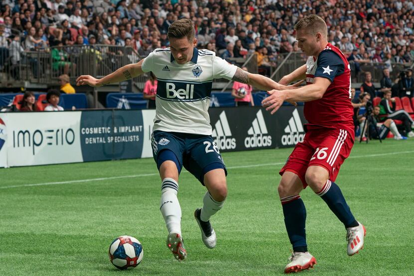 Vancouver Whitecaps' Jakob Nerwinski, left, tries to keep FC Dallas' John Nelson away from...