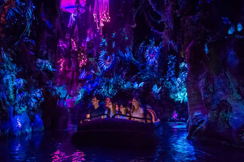 The Na'vi River Journey floats past animated creatures, plants and a shaman at Pandora — The...