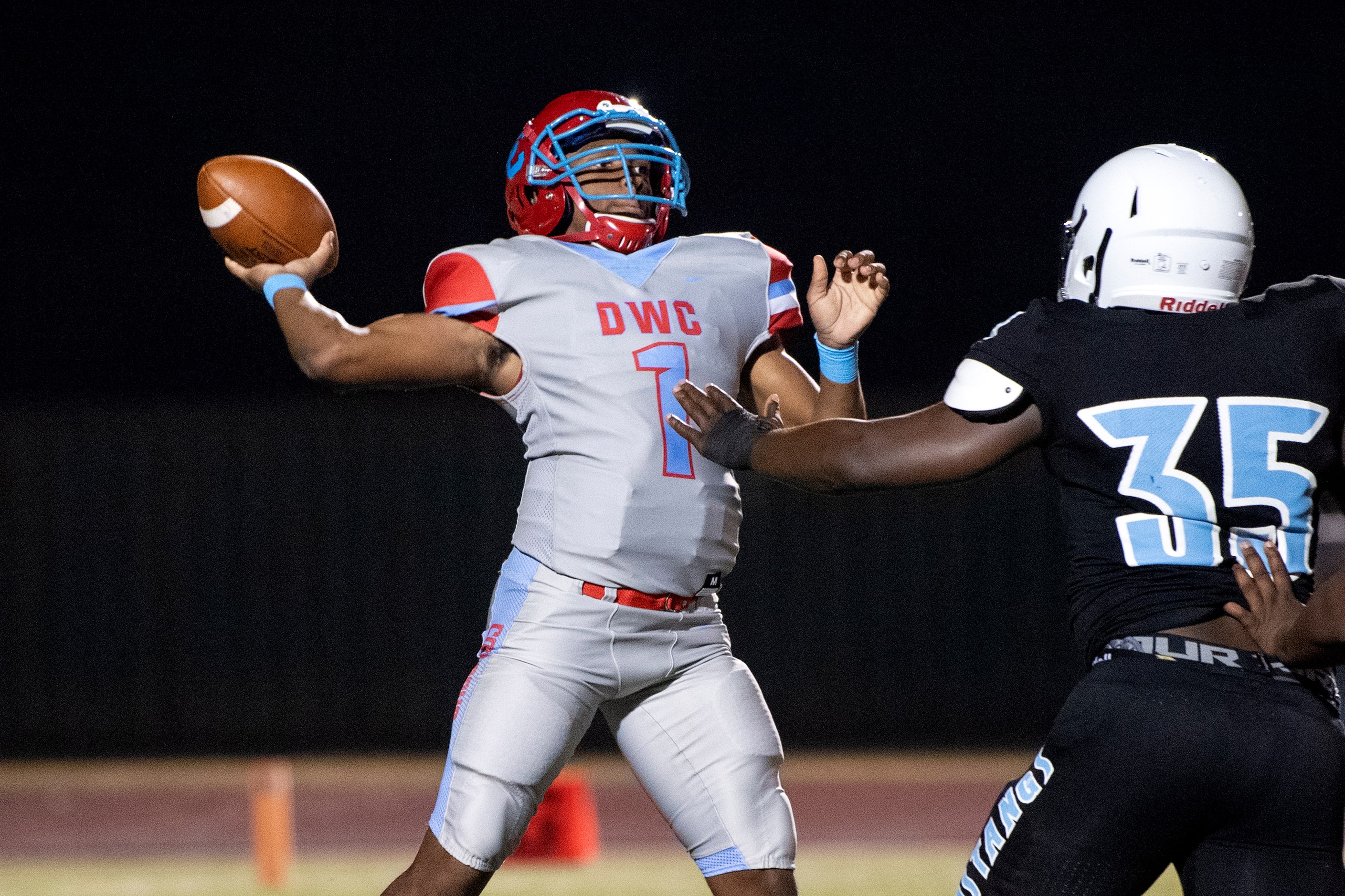 Carter senior quarterback Kace Williams (1) throws downfield as Roosevelt defensive tackle...