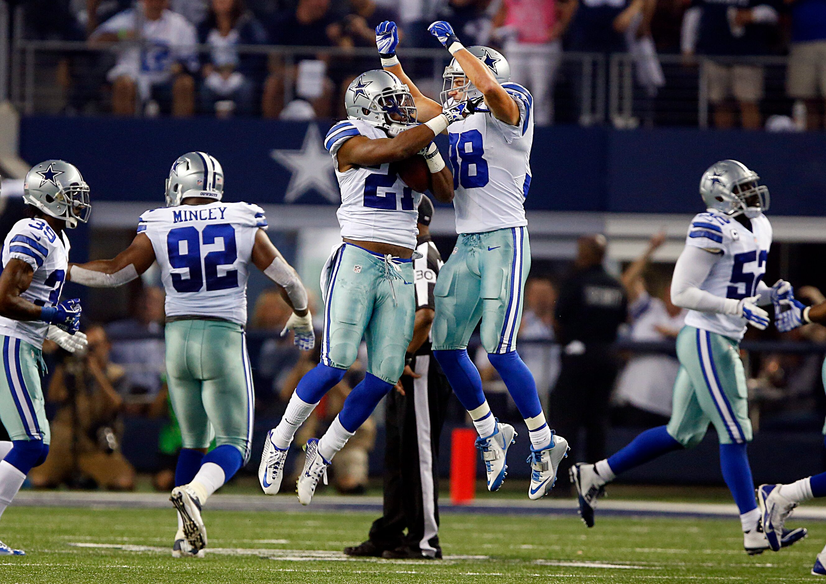 Dallas Cowboys strong safety Jeff Heath (38) helps celebrate strong safety J.J. Wilcox's...