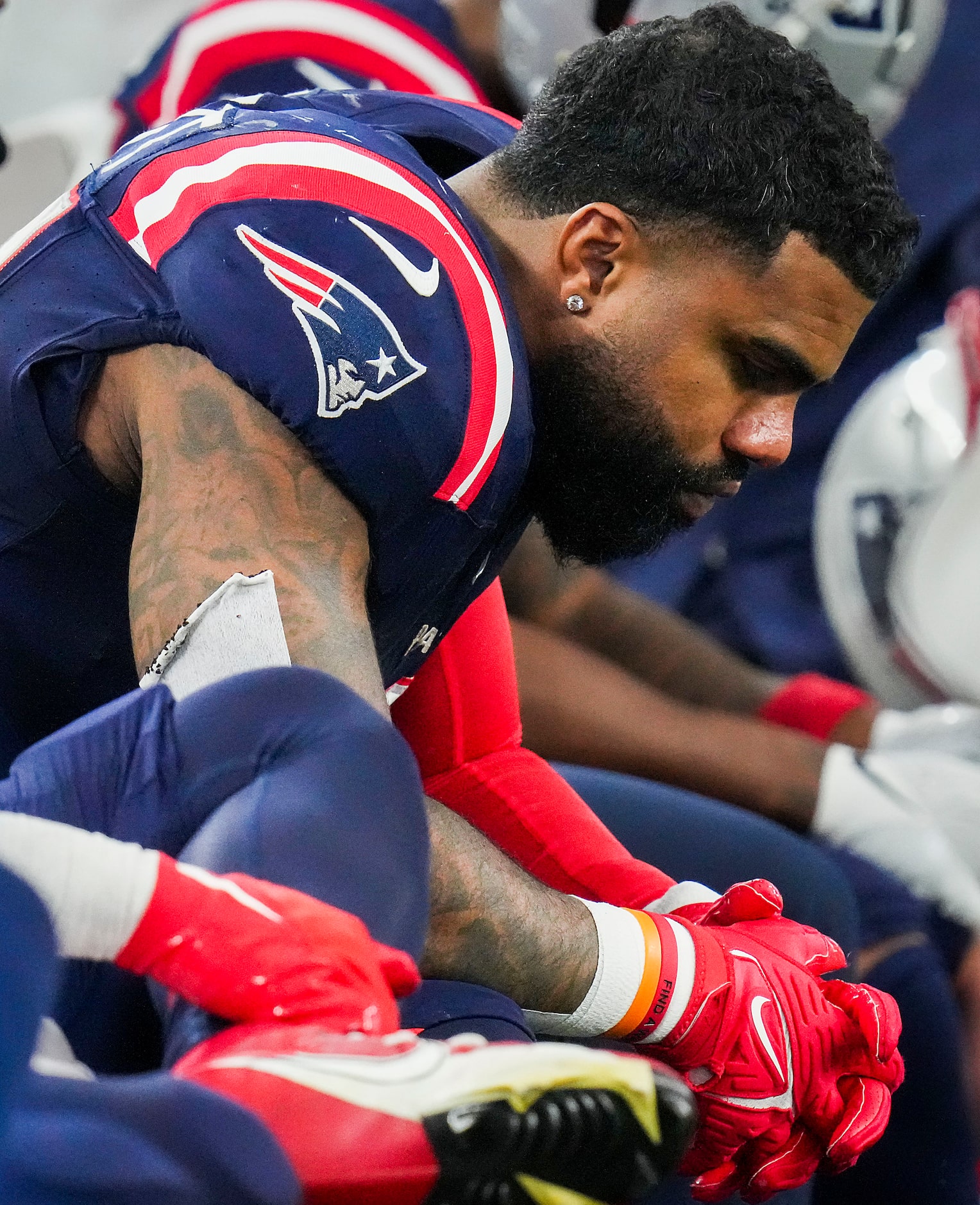 New England Patriots running back Ezekiel Elliott looks on from the bench during the second...