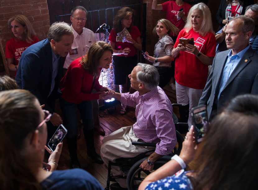 Texas Gov. Greg Abbott greets Attorney General Ken Paxton and his wife Angela Paxton before...