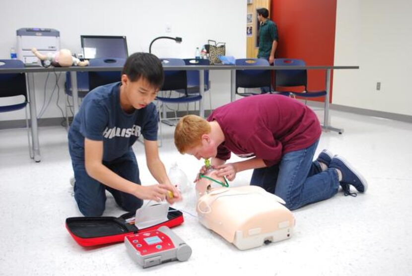 
Sophomores Orion Tse and Brandon Beech demonstrate the CPR technique learned at the Health...