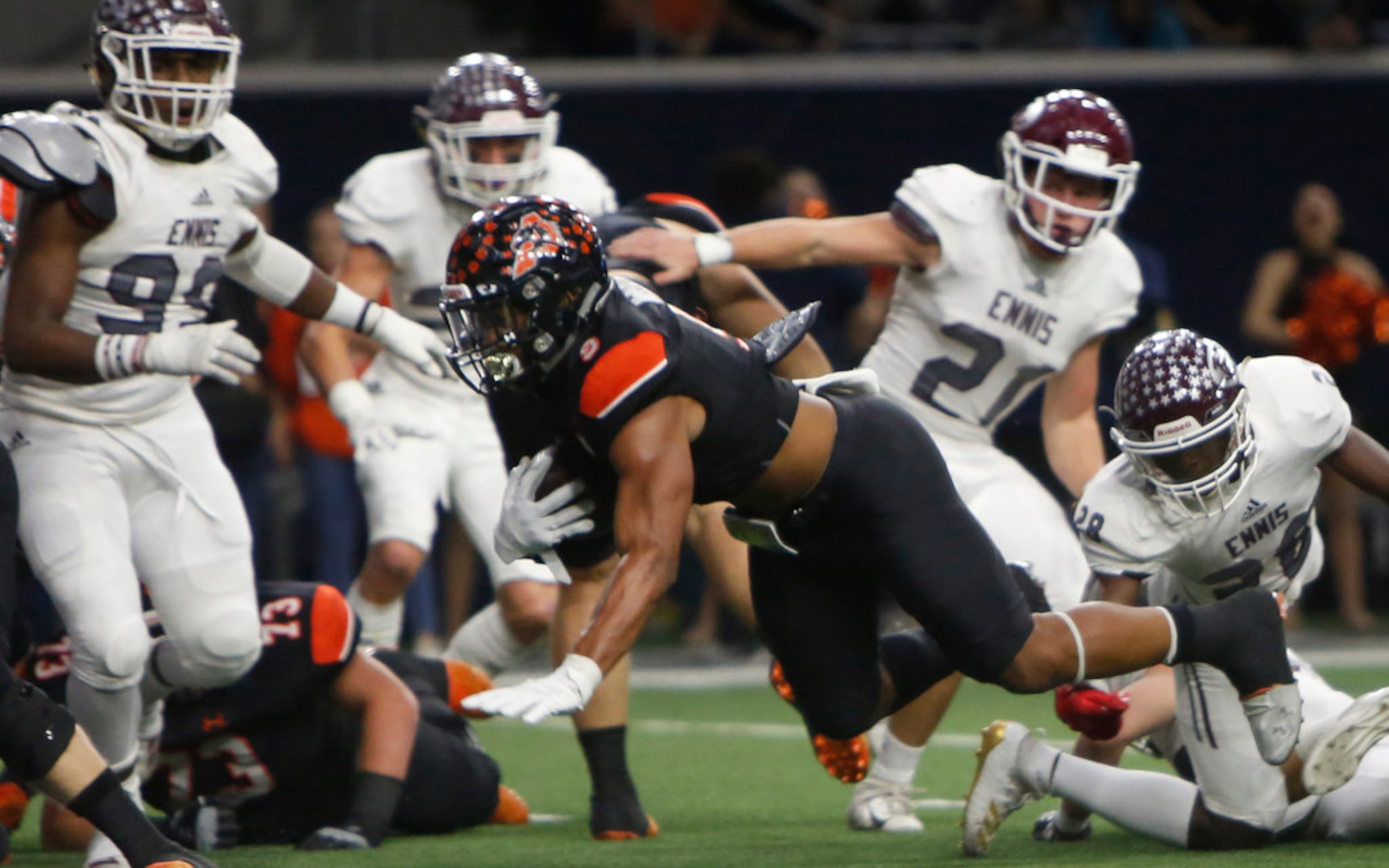 Aledo running back Jase McClellan (9) dives behind left tackle past a host of Ennis...