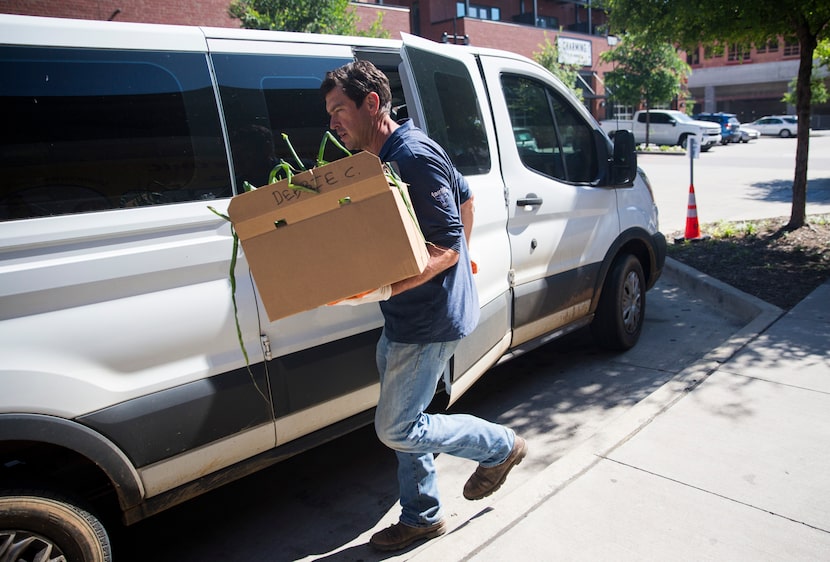 Farmer John Kilburn of Comeback Creek Farm drops off a box of fruits and vegetables to...