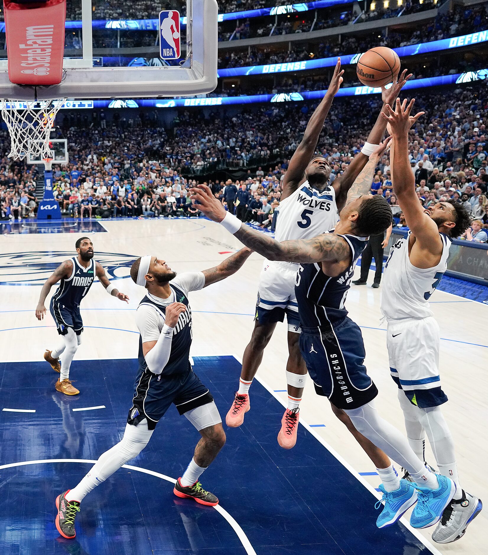 Minnesota Timberwolves guard Anthony Edwards (5) and  center Karl-Anthony Towns (32) fight...