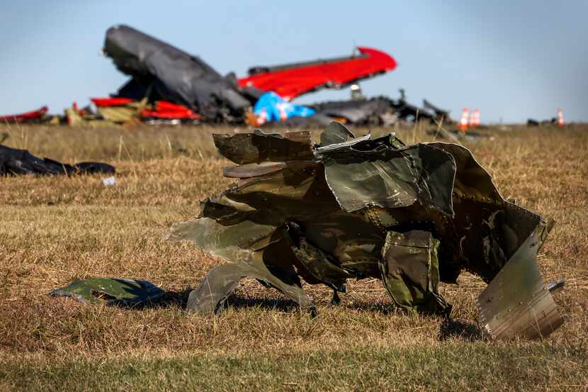 Debris lays across the open field at the Dallas Executive Airport on Nov. 13 after a Boeing...