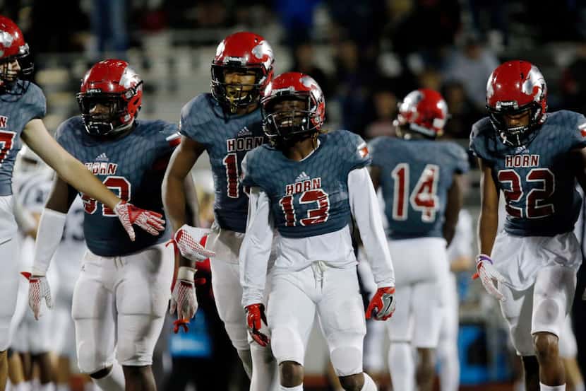Mesquite Horn High's Breon Emerson (13) and teammates look relieved as they come off the...