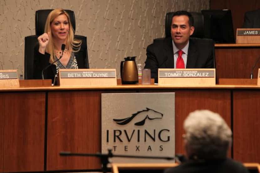 Irving City Manager Tommy Gonzalez and Mayor Beth Van Duyne listen to remarks at a February...