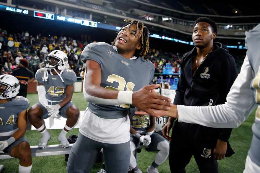 South Oak Cliff running back Danny Green (21) is congratulated on the win as the team...