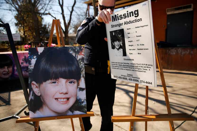Arlington Police Sgt. Michael Chitty removes a the original 'Missing' alert and a photo of...