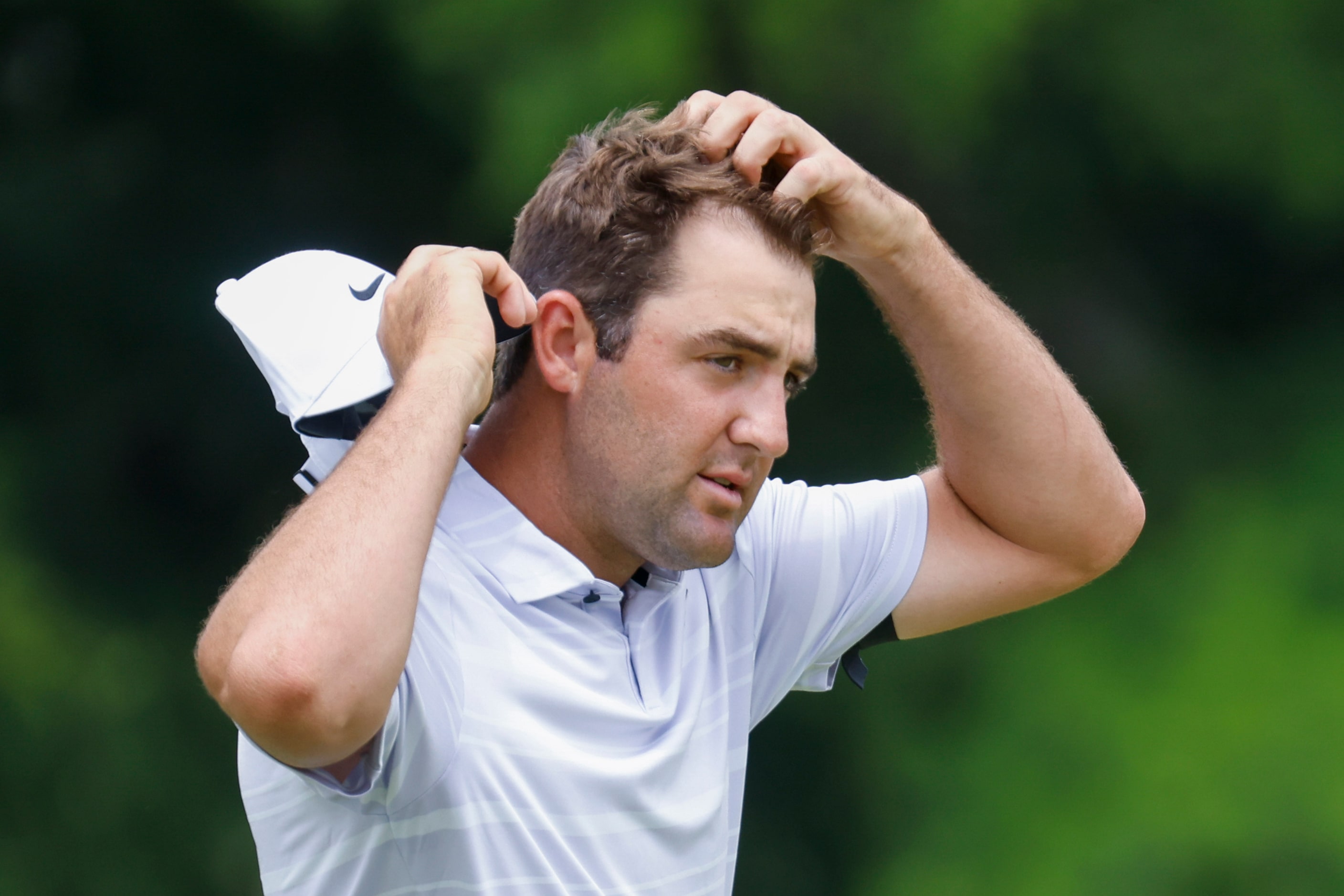 Scottie Scheffler of United States walks off after putting on the ninth hole during the...