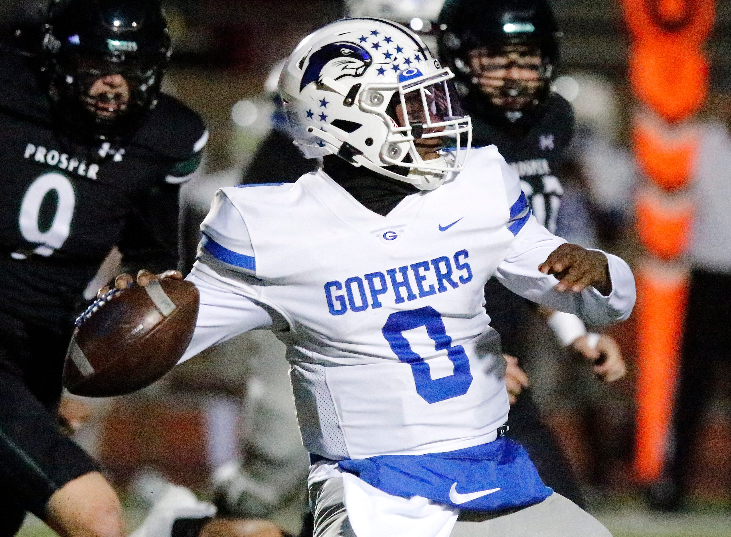 Grand Prairie High School quarterback Savion Red (0) throws a pass during the first half as...