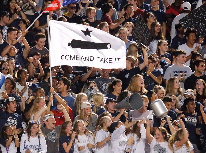 The Lone Star High School student section celebrate a touchdown to tie the score just before...