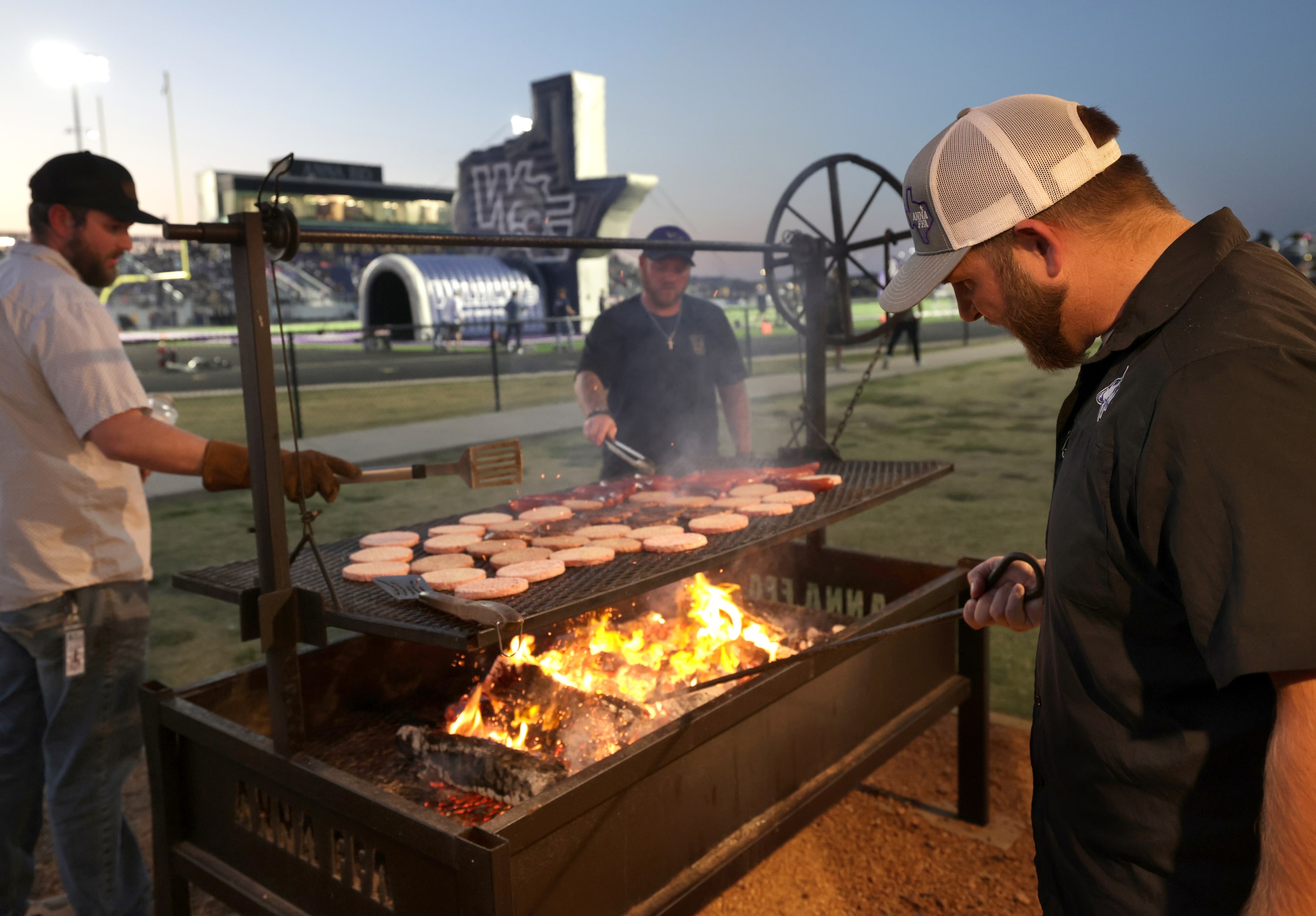 The Anna concession stand team grilles burgers and hotdogs during the Prosper Walnut Grove...