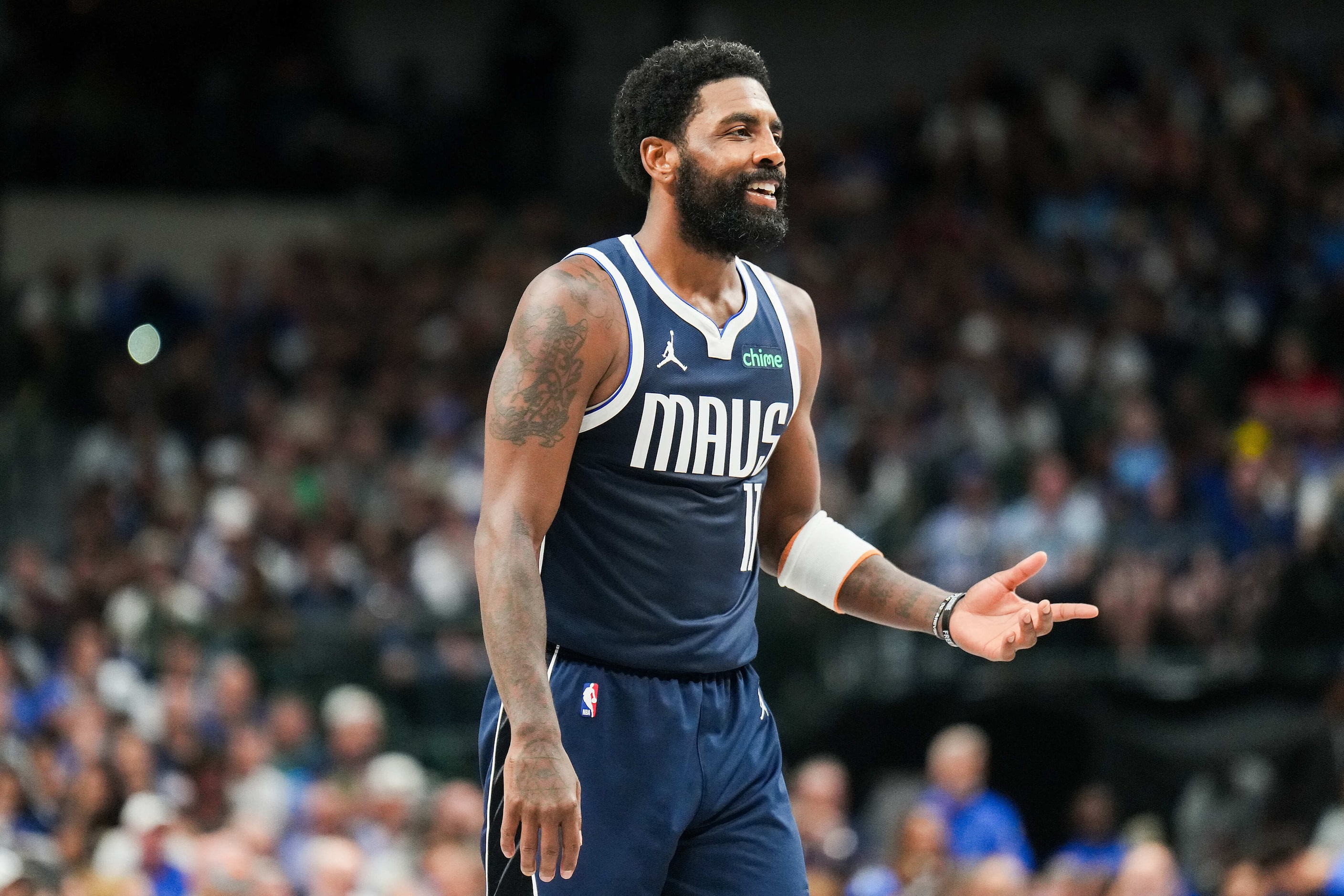 Dallas Mavericks guard Kyrie Irving (11) reacts after a play during the first half of an NBA...