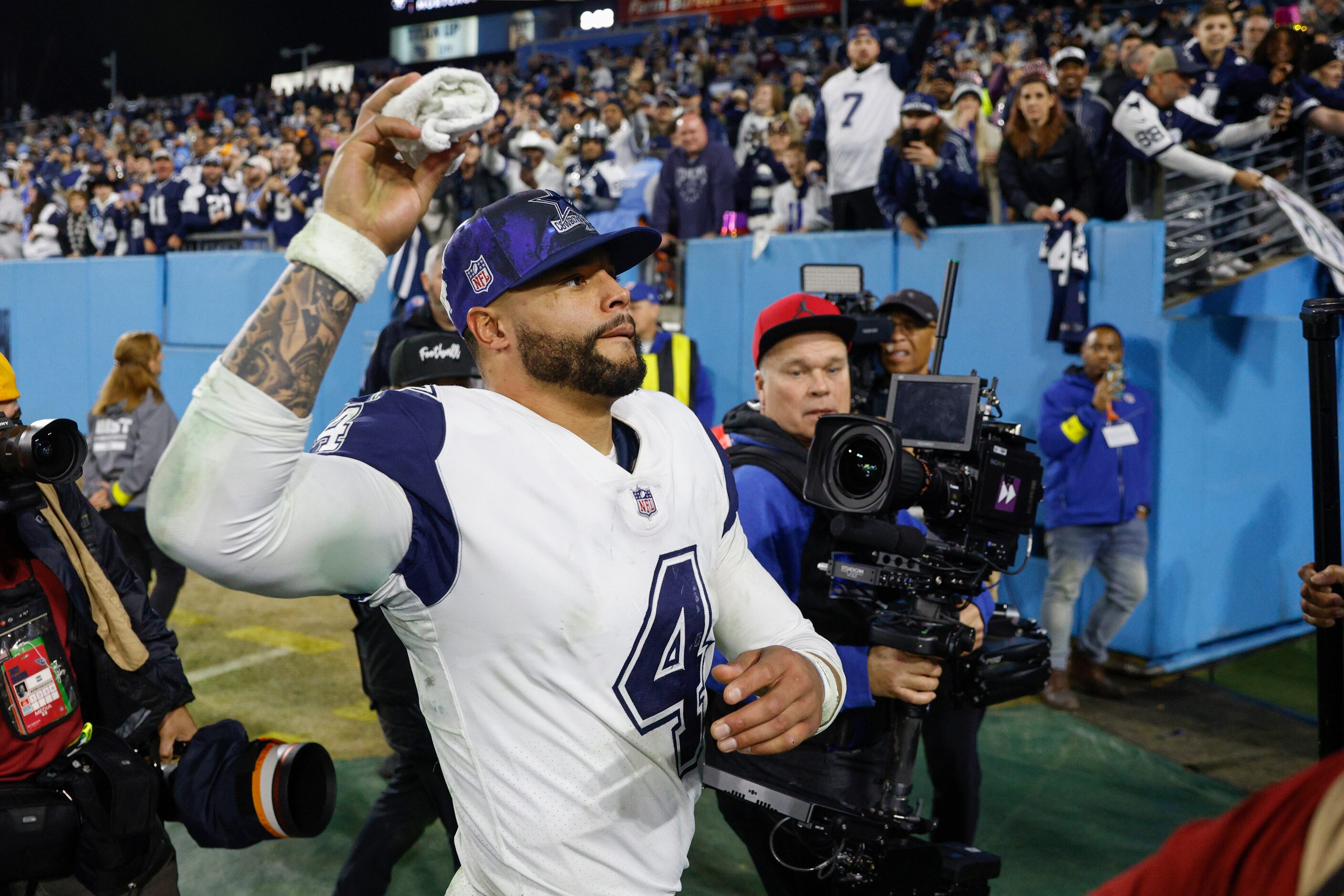 Dallas Cowboys quarterback Dak Prescott (4) tosses a towel to Cowboys fans after an NFL game...