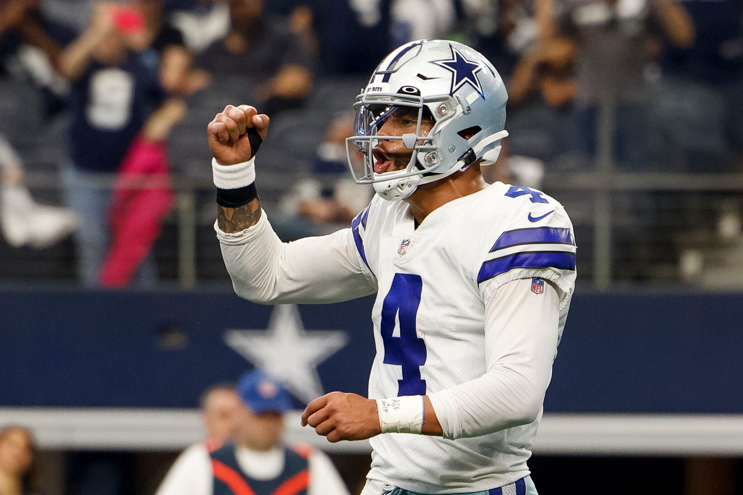 Dallas Cowboys quarterback Dak Prescott (4) celebrates a touchdown by running back Ezekiel...