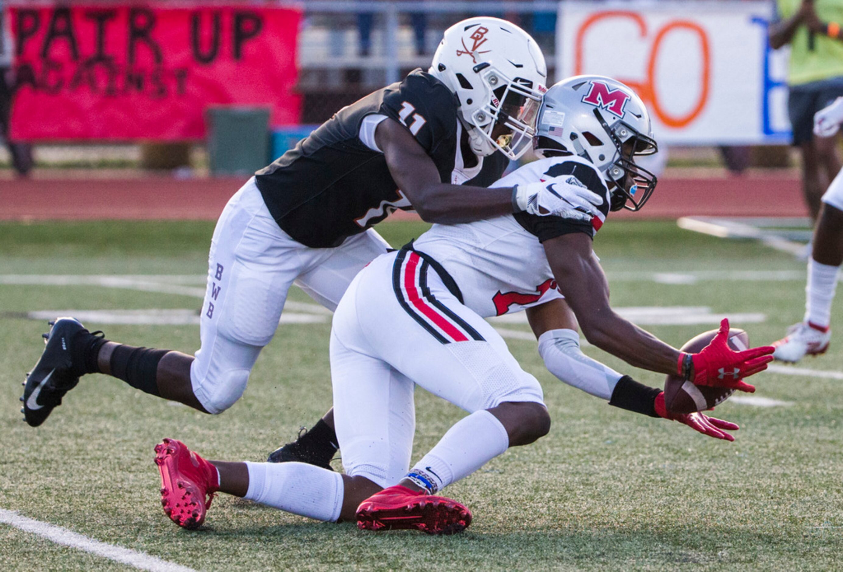 Flower Mound Marcus wide receiver J. Michael Sturdivant (7) catches a pass while being...