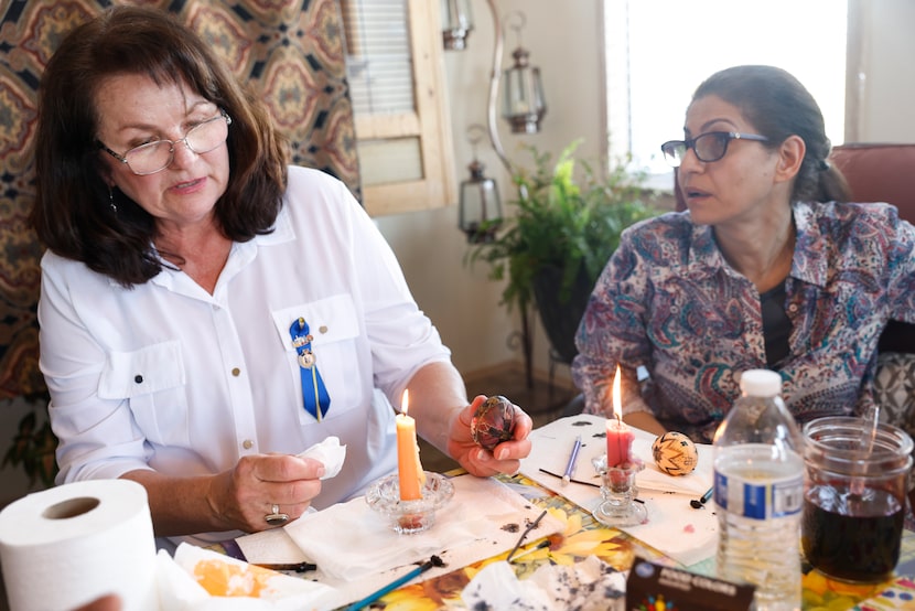 Chystya Geremesz shows Masoumeh Ghiasvand how to remove the wax off of an egg once its...