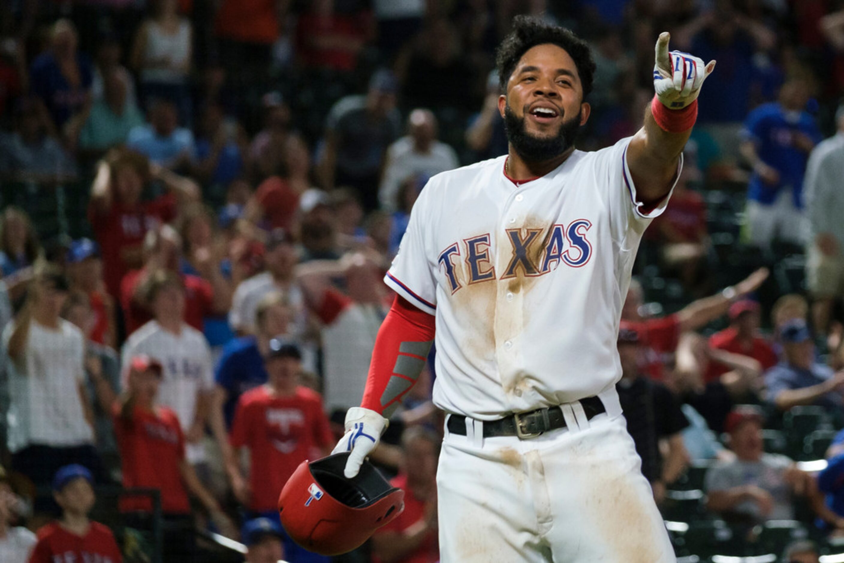 Texas Rangers shortstop Elvis Andrus celebrates after scoring to tie the game in the bottom...