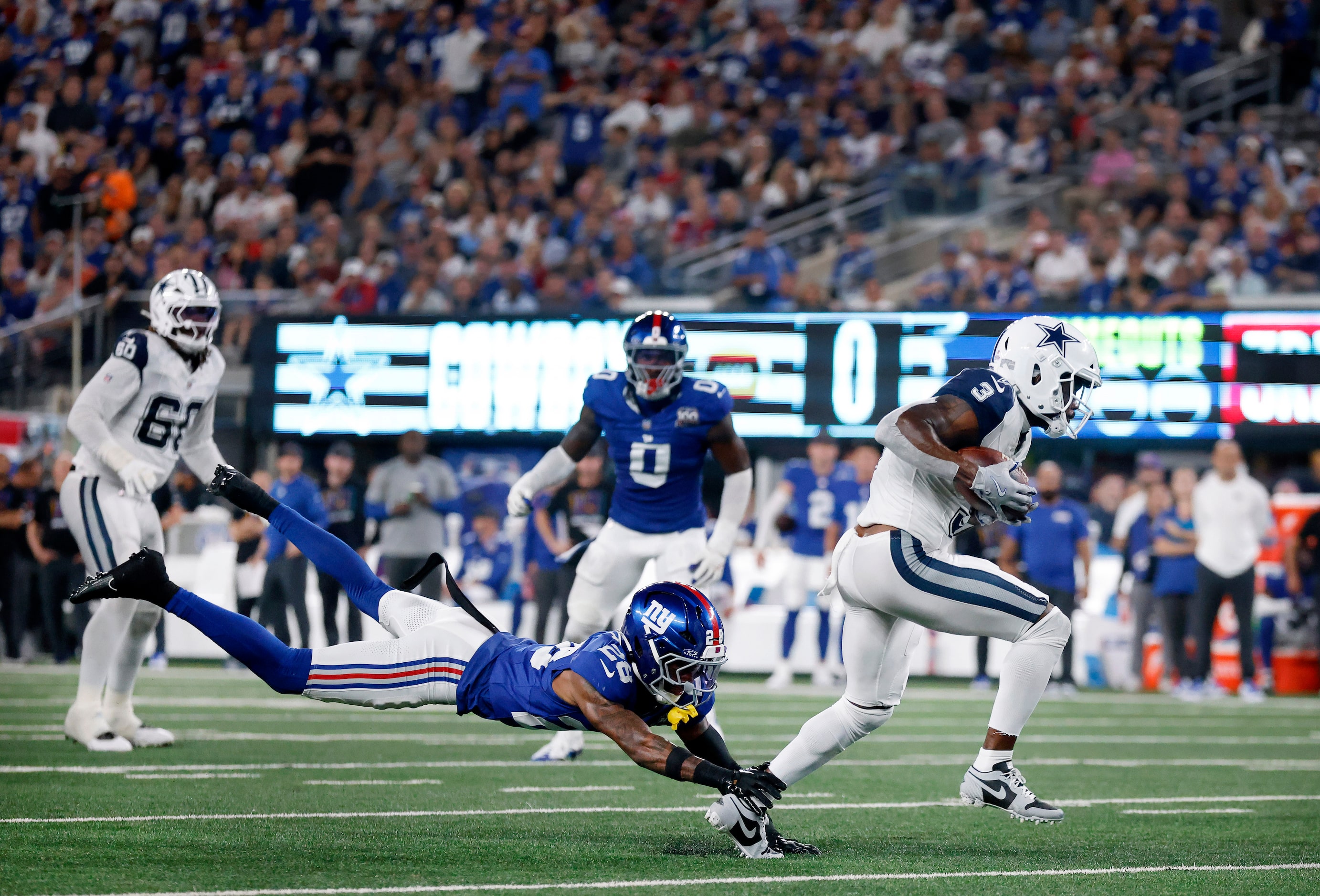 New York Giants cornerback Cor'Dale Flott (28) makes a diving tackle attempt of Dallas...