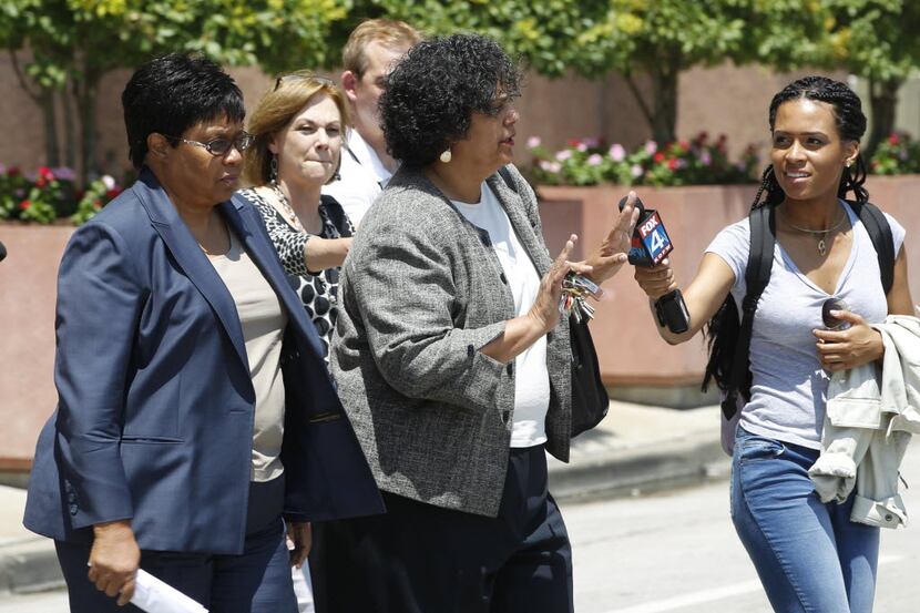 Kathy Nealy (left) walks behind her attorney Cheryl Wattley (right) after exiting the Earle...