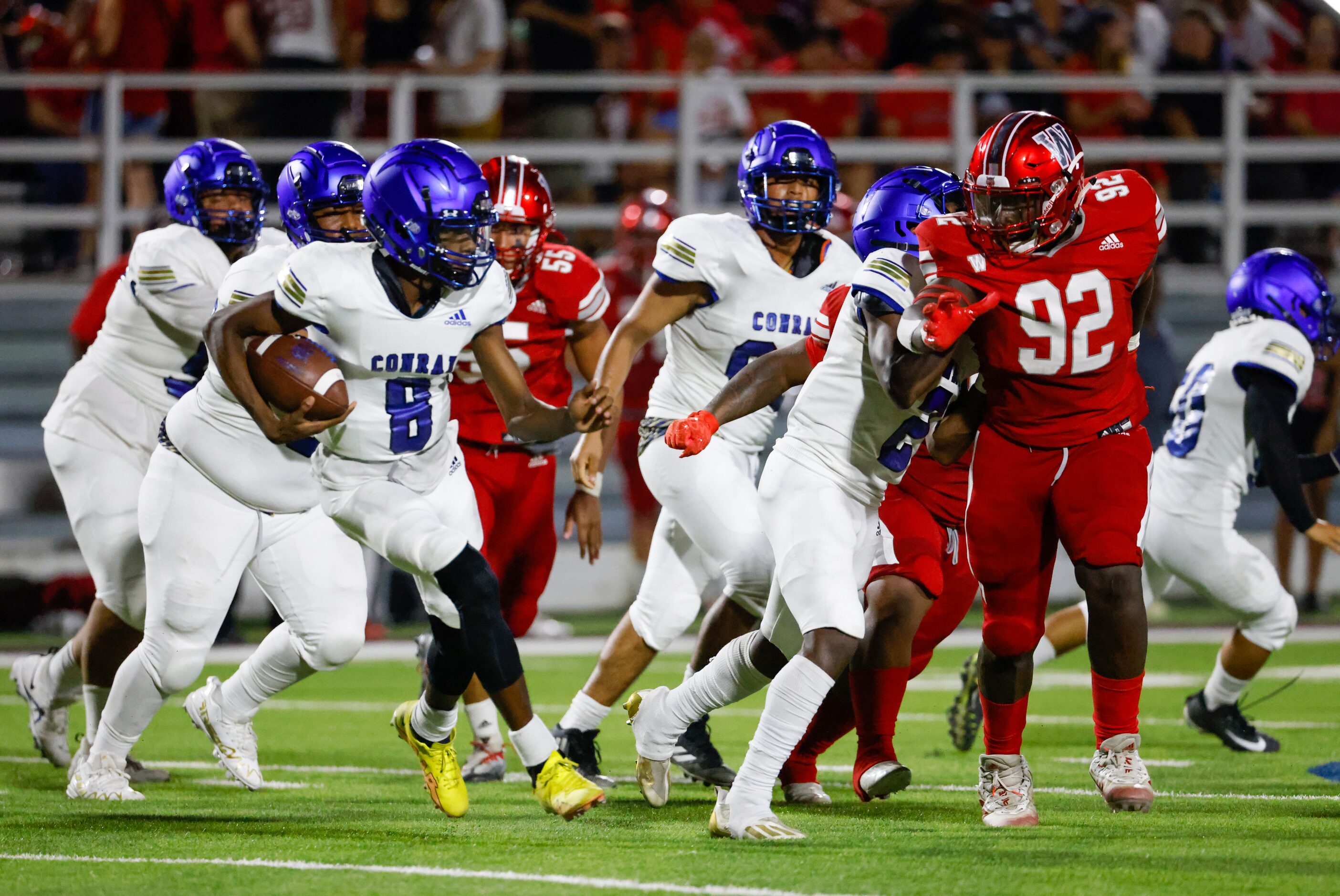 Conrad quarterback Ladavian Frost-Harris (8) carries the ball to a first down during the...