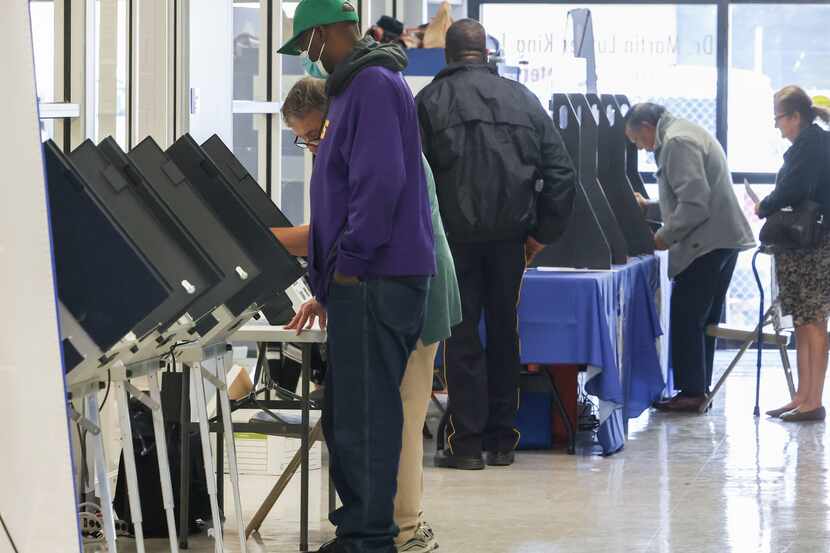 Community members take part in early voting for the May 6 general election at the Dr. Martin...