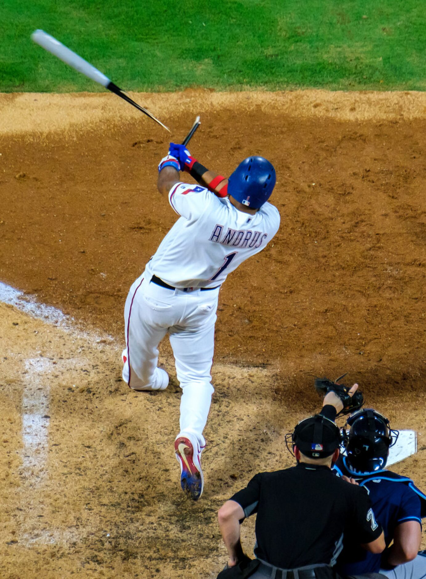 Texas Rangers shortstop Elvis Andrus breaks his bat as he drives in a run with a single...