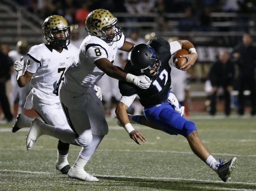 Hebron quarterback Clayton Tune (12) is sacked by Plano East defensive back Reuben Donald...
